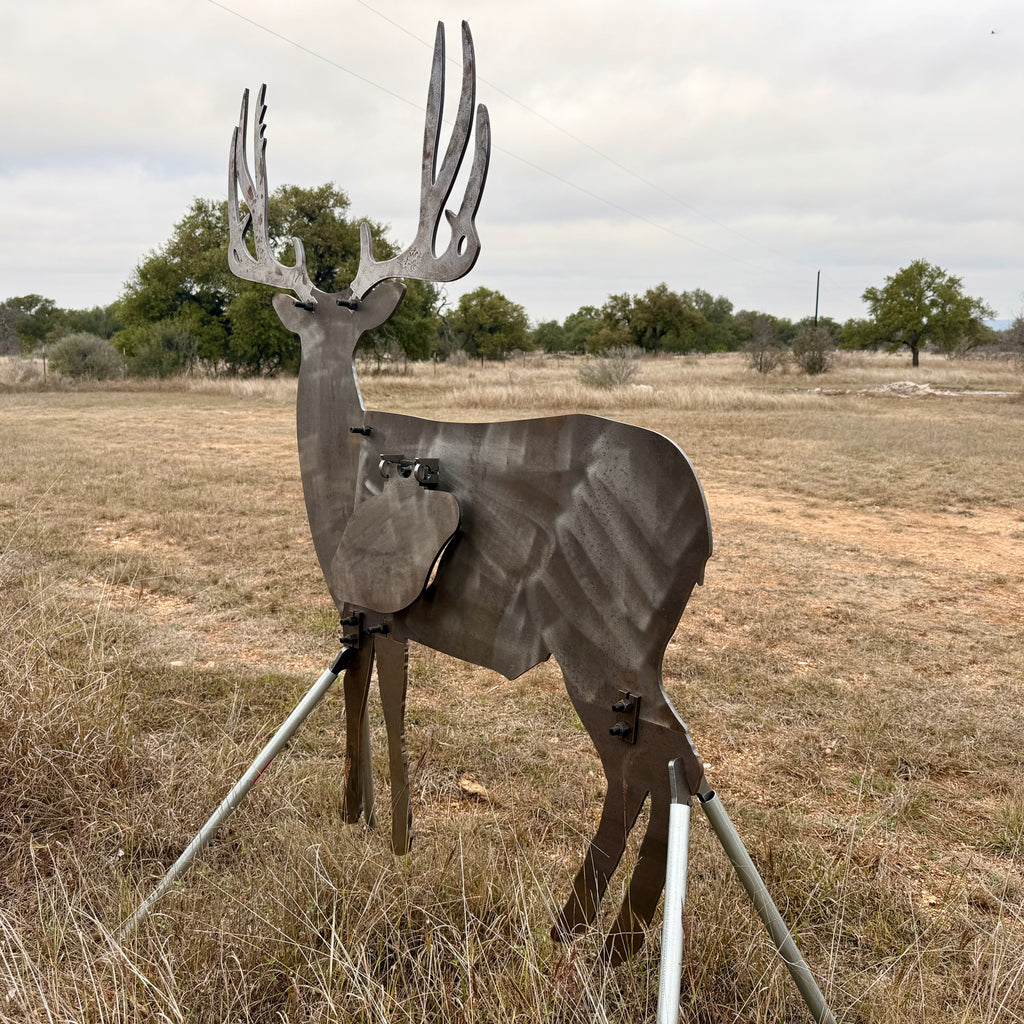 AR500 Steel Mule Deer Buck target on a stand in a grassy outdoor area with trees in the background