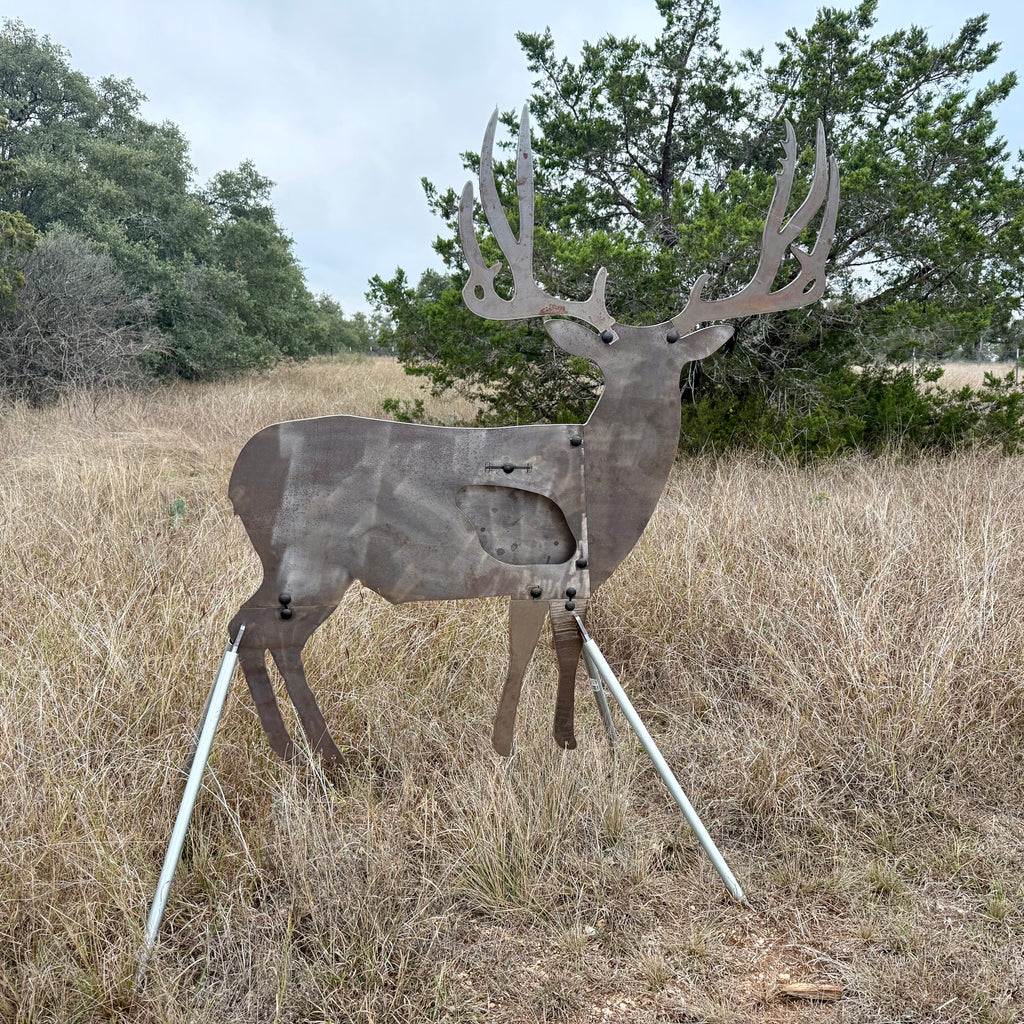 AR500 Steel Mule Deer Buck target on a stand in a grassy outdoor area with trees in the background