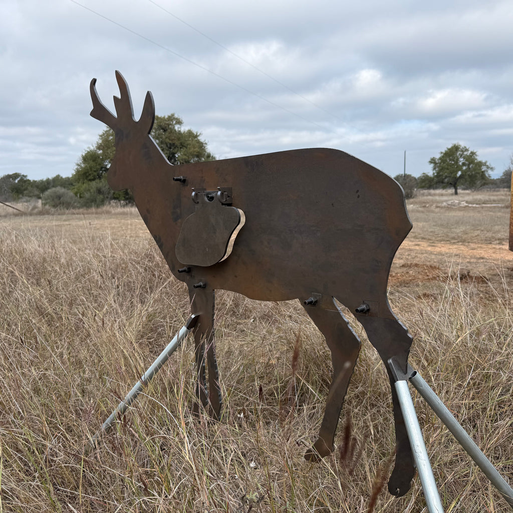 AR500 Steel Pronghorn Antelope target on a stand in a grassy outdoor area with trees in the background
