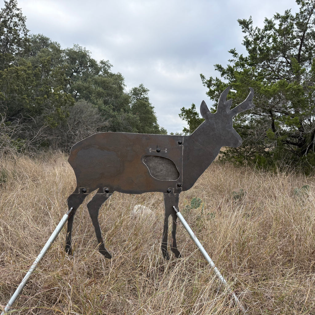 AR500 Steel Pronghorn Antelope target on a stand in a grassy outdoor area with trees in the background